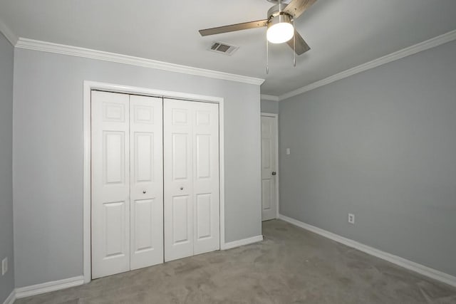 unfurnished bedroom featuring carpet flooring, ceiling fan, a closet, and ornamental molding