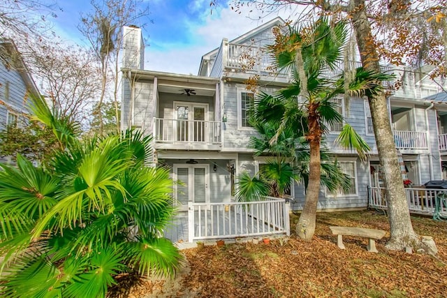 back of house featuring ceiling fan, a porch, a balcony, and french doors