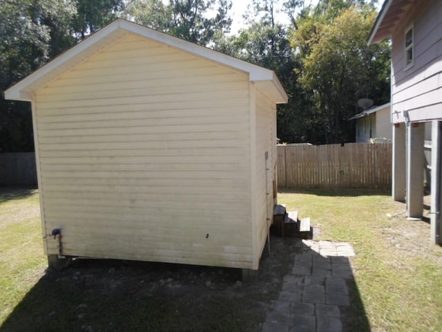 view of side of home with a yard