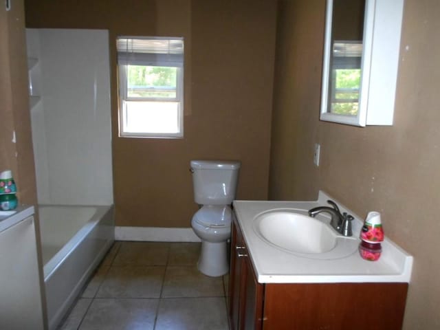 full bathroom featuring vanity, toilet, tile patterned floors, and plus walk in shower