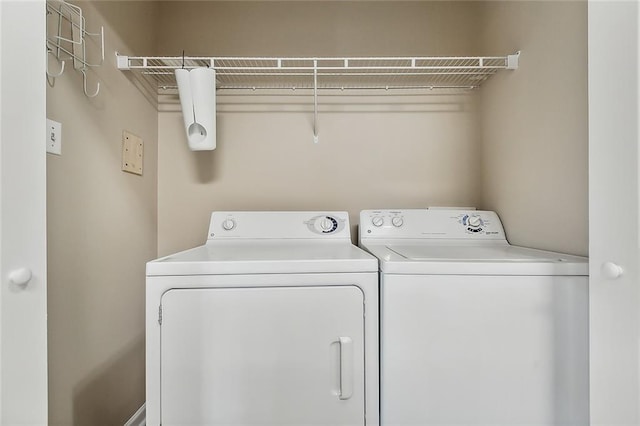 clothes washing area featuring separate washer and dryer