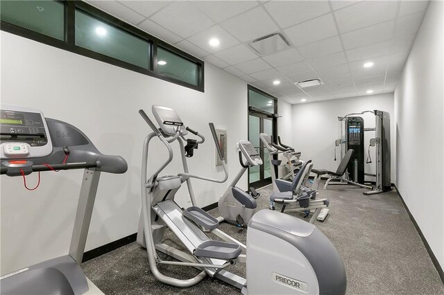 917 Conti St Unit 205, New Orleans, LA 70112 - exercise room with baseboards, a paneled ceiling, and recessed lighting