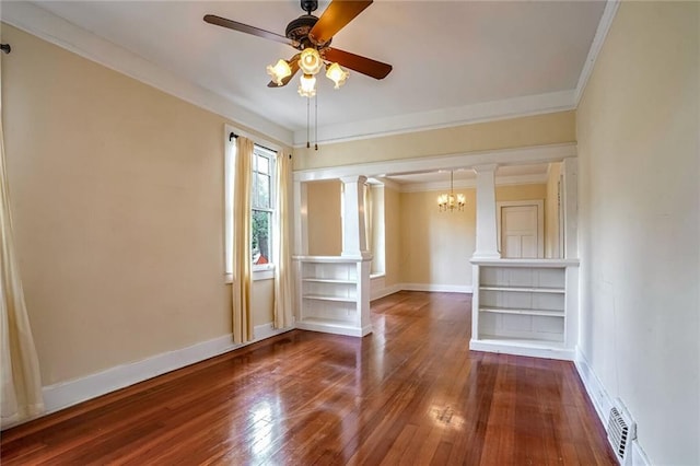 empty room featuring ceiling fan with notable chandelier, wood-type flooring, crown molding, and decorative columns