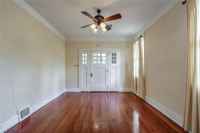 entrance foyer with ceiling fan, wood-type flooring, and ornamental molding