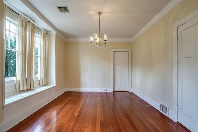 unfurnished room with dark hardwood / wood-style floors, crown molding, and a chandelier