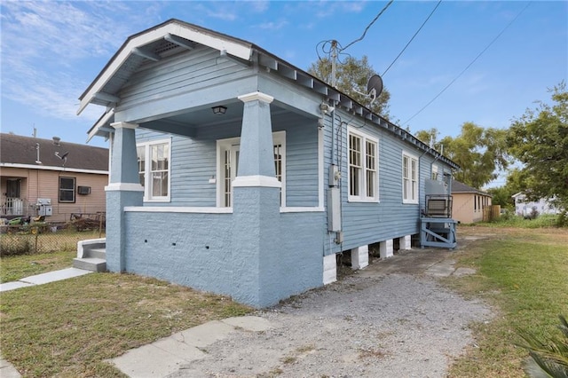 view of property exterior with a yard and covered porch