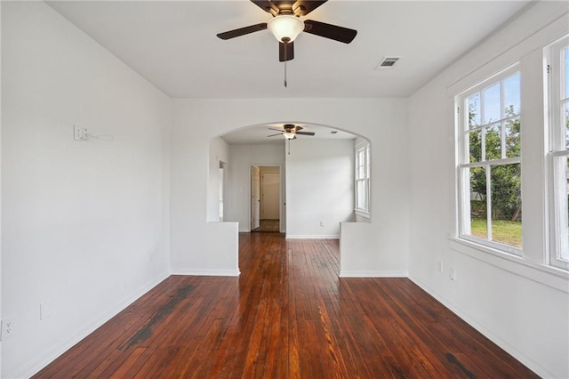 spare room with ceiling fan, dark hardwood / wood-style flooring, and plenty of natural light