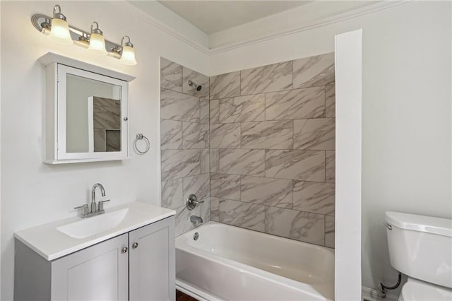 full bathroom featuring toilet, tiled shower / bath combo, and vanity