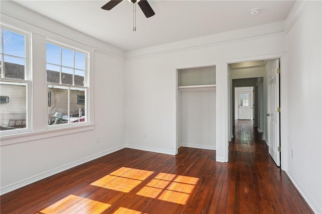 unfurnished bedroom featuring dark hardwood / wood-style flooring, a closet, and ceiling fan