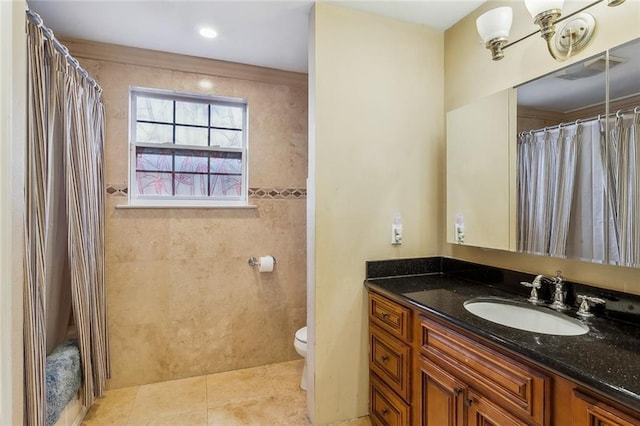 bathroom with toilet, vanity, a shower with shower curtain, and tile patterned floors