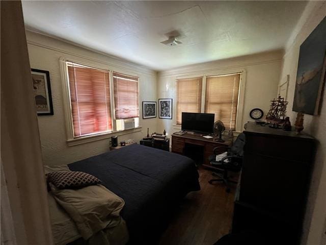 bedroom with hardwood / wood-style flooring