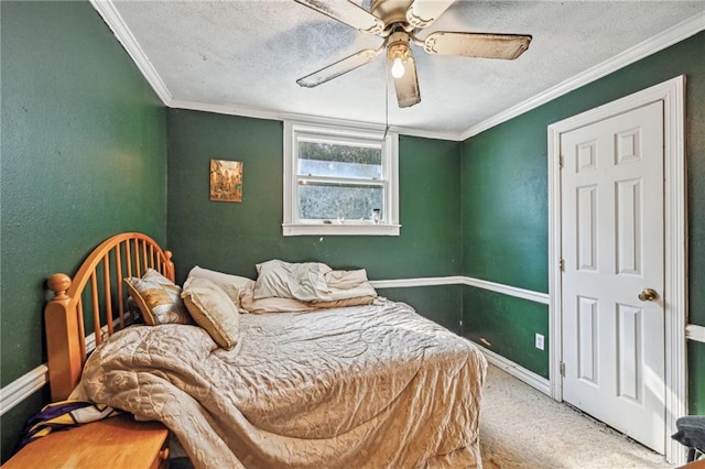 carpeted bedroom with ceiling fan, ornamental molding, and a textured ceiling