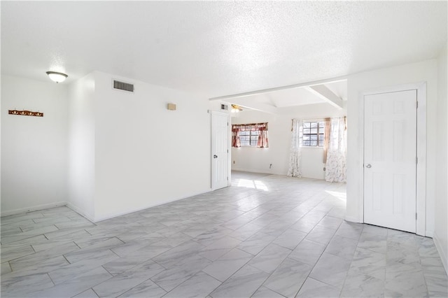 empty room with a textured ceiling