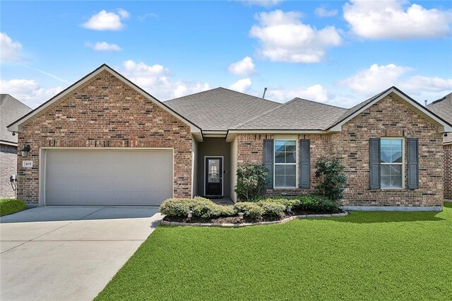 view of front facade with a front yard and a garage