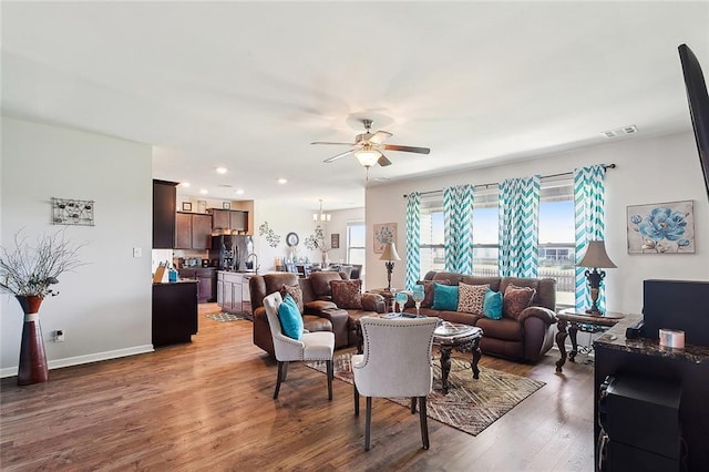 living room featuring wood-type flooring and ceiling fan