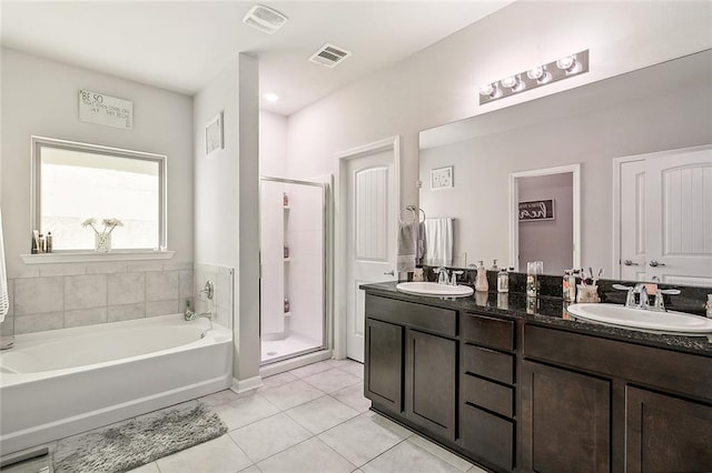 bathroom featuring vanity, separate shower and tub, and tile patterned floors