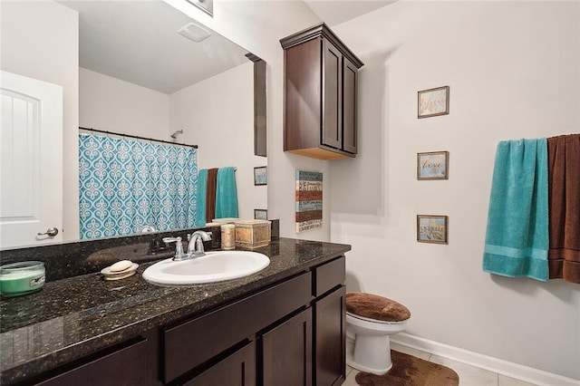 bathroom with vanity, toilet, tile patterned floors, and walk in shower