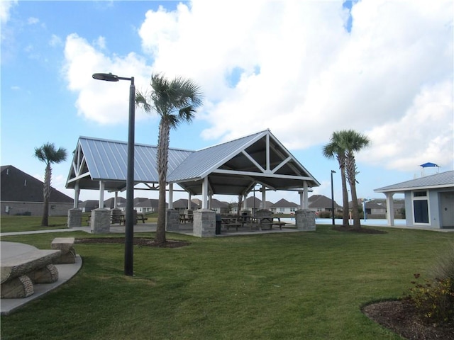 view of property's community featuring a yard, a gazebo, and an outdoor kitchen