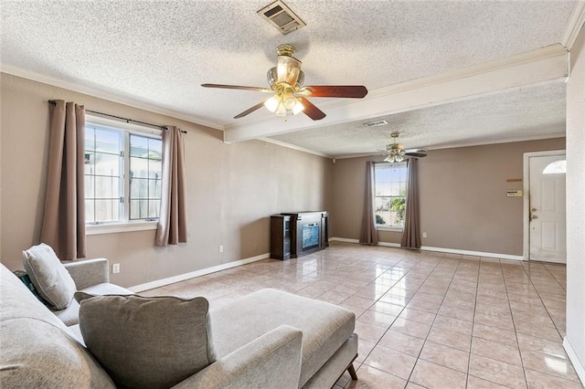 tiled living room with a textured ceiling, ceiling fan, and ornamental molding