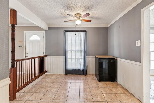 interior space featuring ceiling fan, crown molding, beamed ceiling, and a textured ceiling