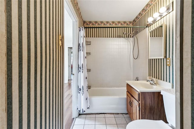 full bathroom with tile patterned floors, vanity, toilet, and shower / bath combo with shower curtain