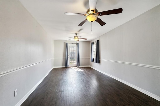 empty room with ceiling fan and dark wood-type flooring