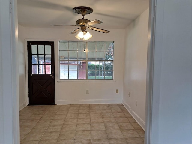 tiled entryway featuring ceiling fan