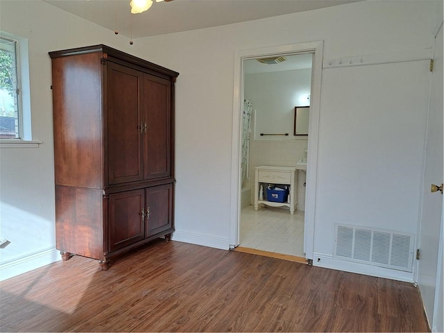 interior space featuring hardwood / wood-style floors and ensuite bath