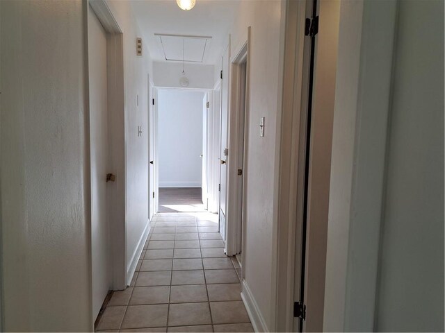 corridor with light tile patterned floors