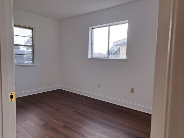 empty room featuring dark hardwood / wood-style flooring