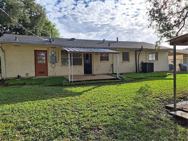 back of property featuring a yard and cooling unit