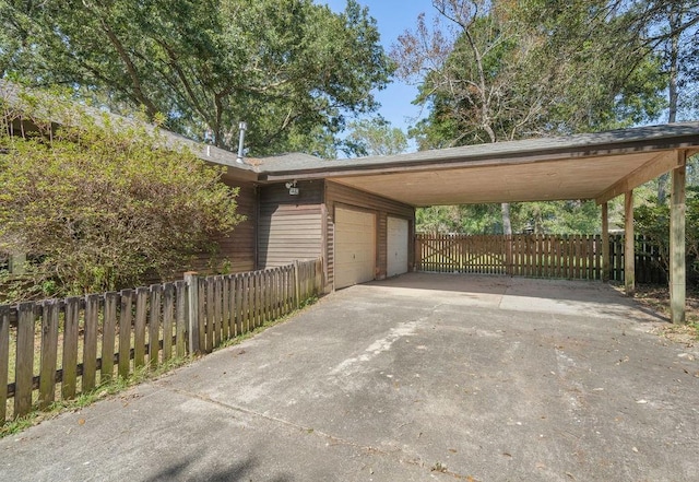 view of vehicle parking featuring a carport and a garage