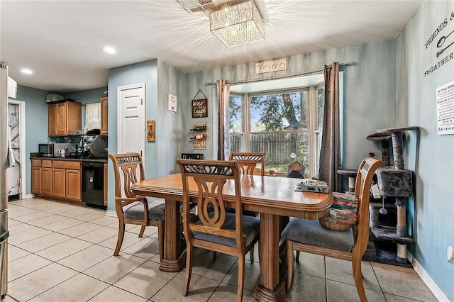 dining space with light tile patterned floors and a chandelier