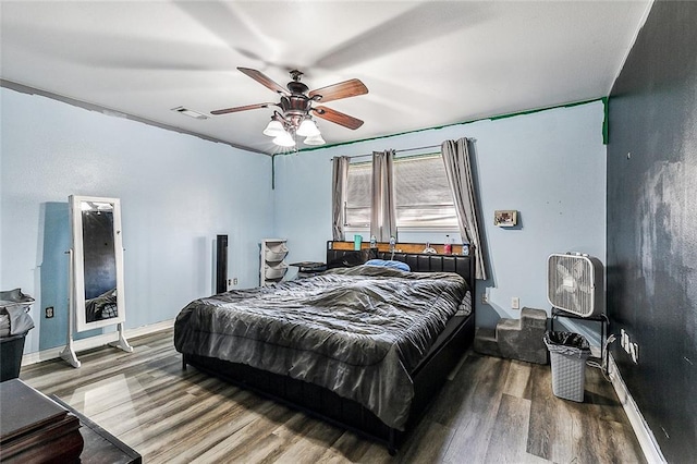 bedroom featuring wood-type flooring and ceiling fan