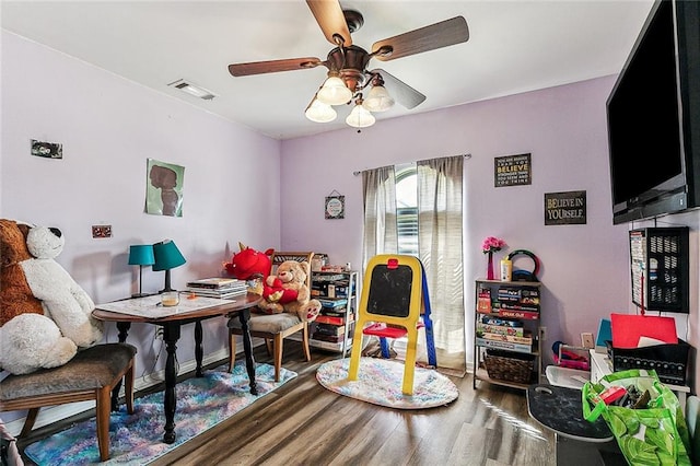 sitting room featuring wood-type flooring and ceiling fan