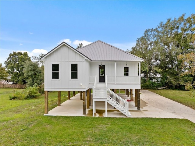 rear view of property featuring a lawn and a patio