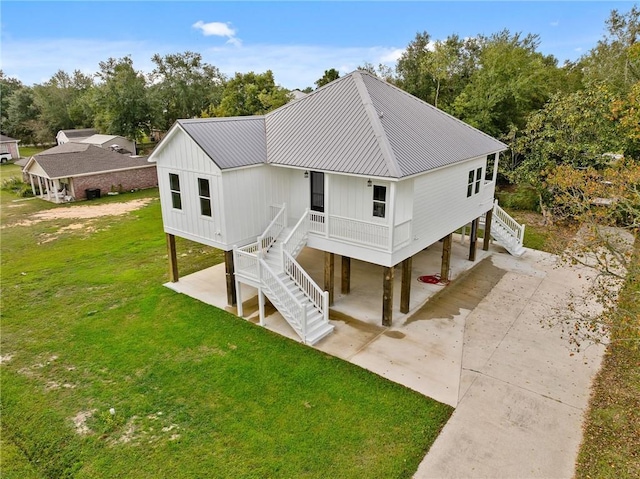 rear view of house with a yard and a carport