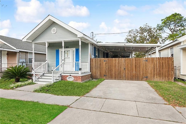 bungalow with covered porch and a carport