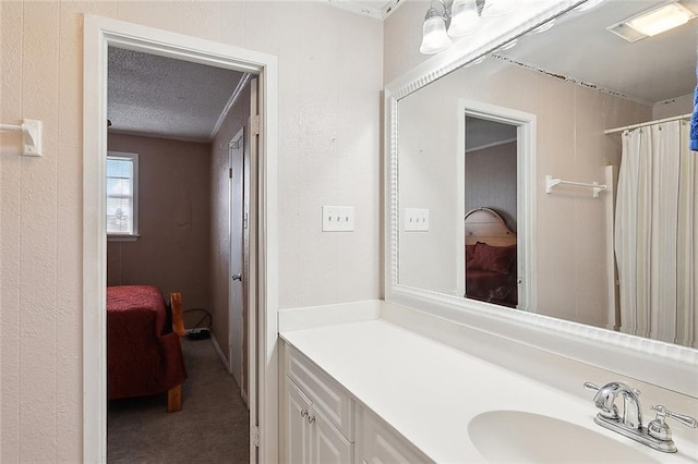 bathroom with vanity and a textured ceiling