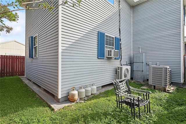 view of home's exterior featuring a yard, ac unit, and central AC unit