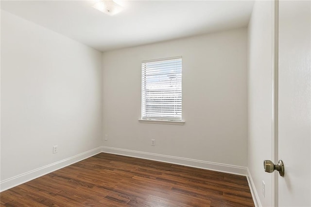 empty room with dark wood-type flooring