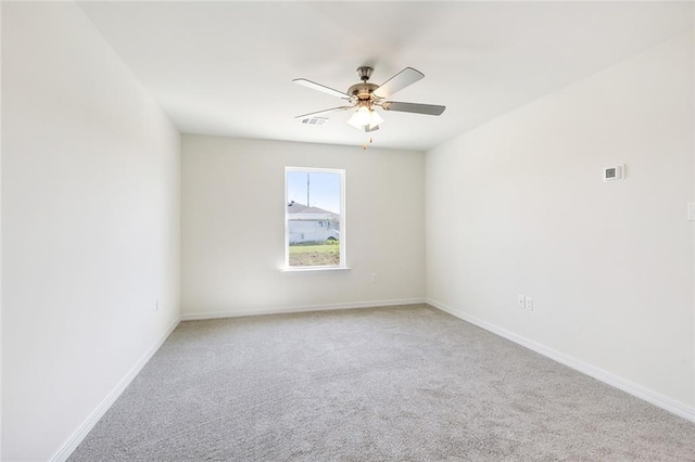 carpeted spare room featuring ceiling fan