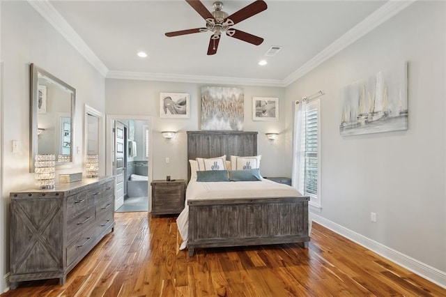 bedroom with connected bathroom, hardwood / wood-style flooring, ceiling fan, and crown molding