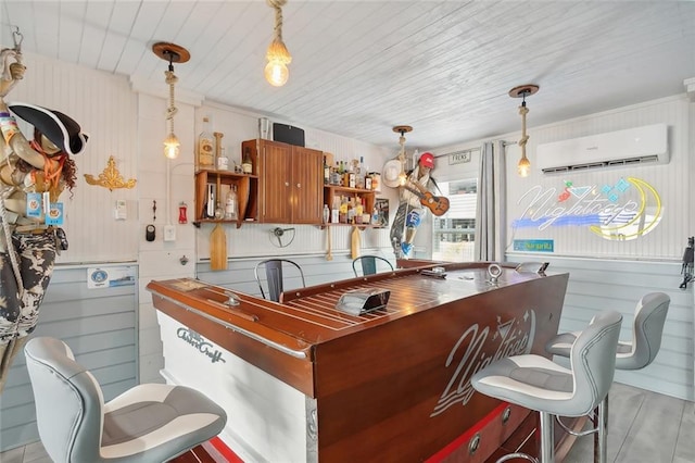 bar with pendant lighting, light hardwood / wood-style floors, an AC wall unit, and wooden ceiling