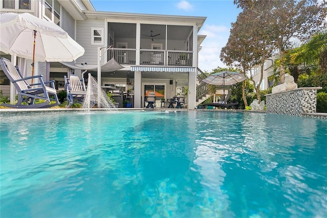 view of pool featuring a sunroom and pool water feature