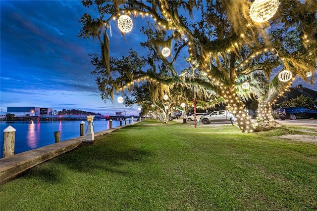 exterior space featuring a lawn and a water view