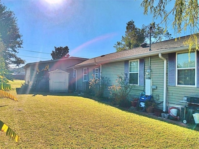 ranch-style home featuring a front yard and a shed