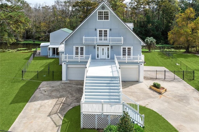 view of front of house with french doors, a garage, and a front lawn