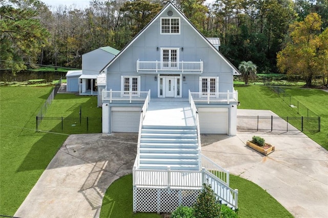 view of front of house featuring french doors, a balcony, concrete driveway, and an attached garage