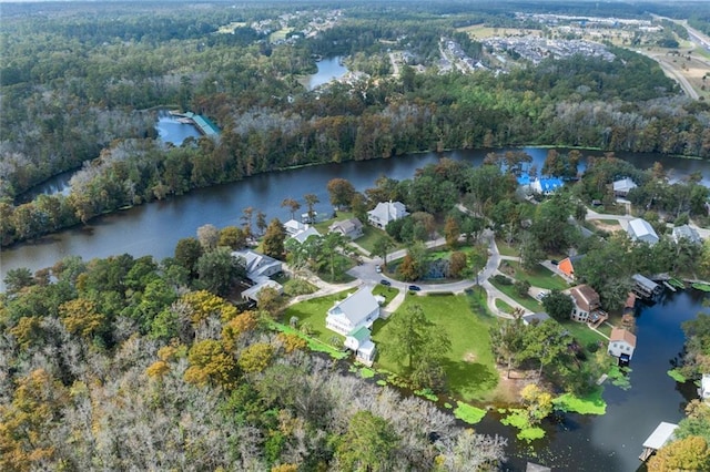 drone / aerial view featuring a water view and a view of trees